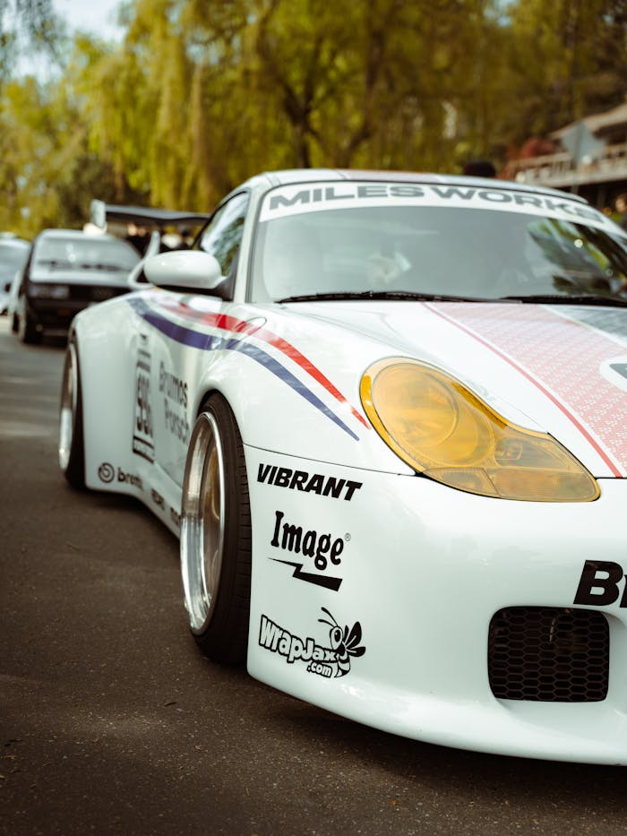 Close-up of a sleek racing car with vibrant decals at an auto show in Seattle, Washington.